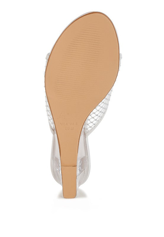 Clear-heel sandal outsole view with tan footbed and white mesh upper