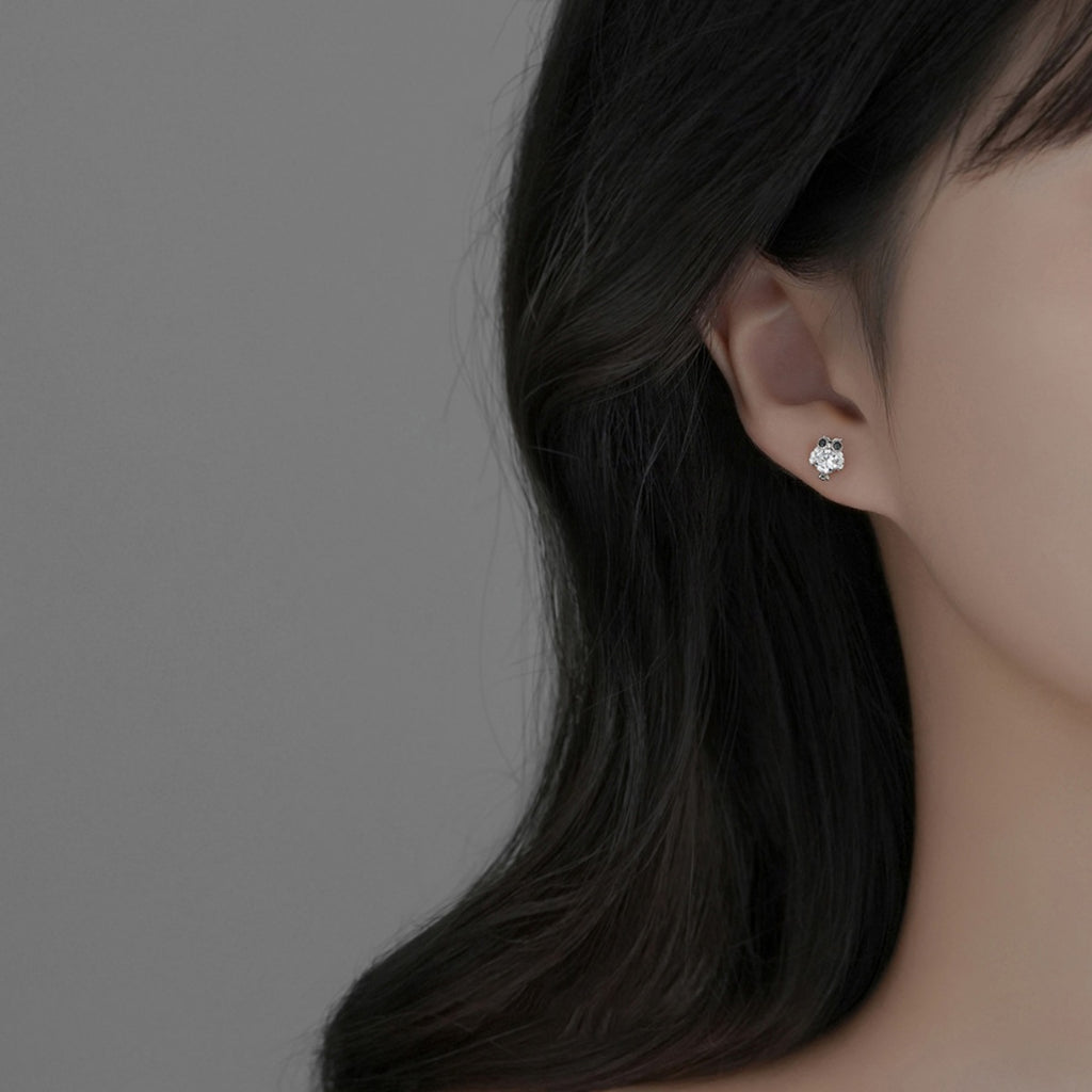 Owl stud earrings on ear: silver owl with clear round stones and black eye details