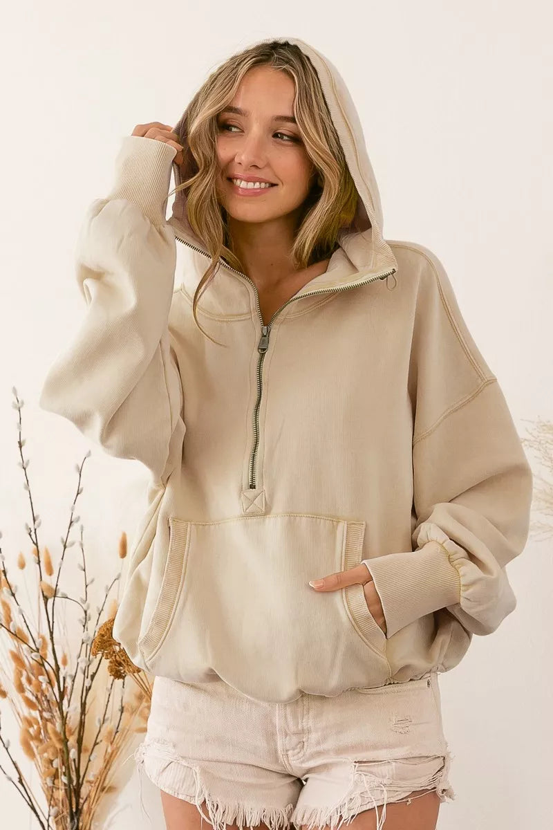 Oatmeal half-zip fleece hoodie with elastic hem and stitched detailing