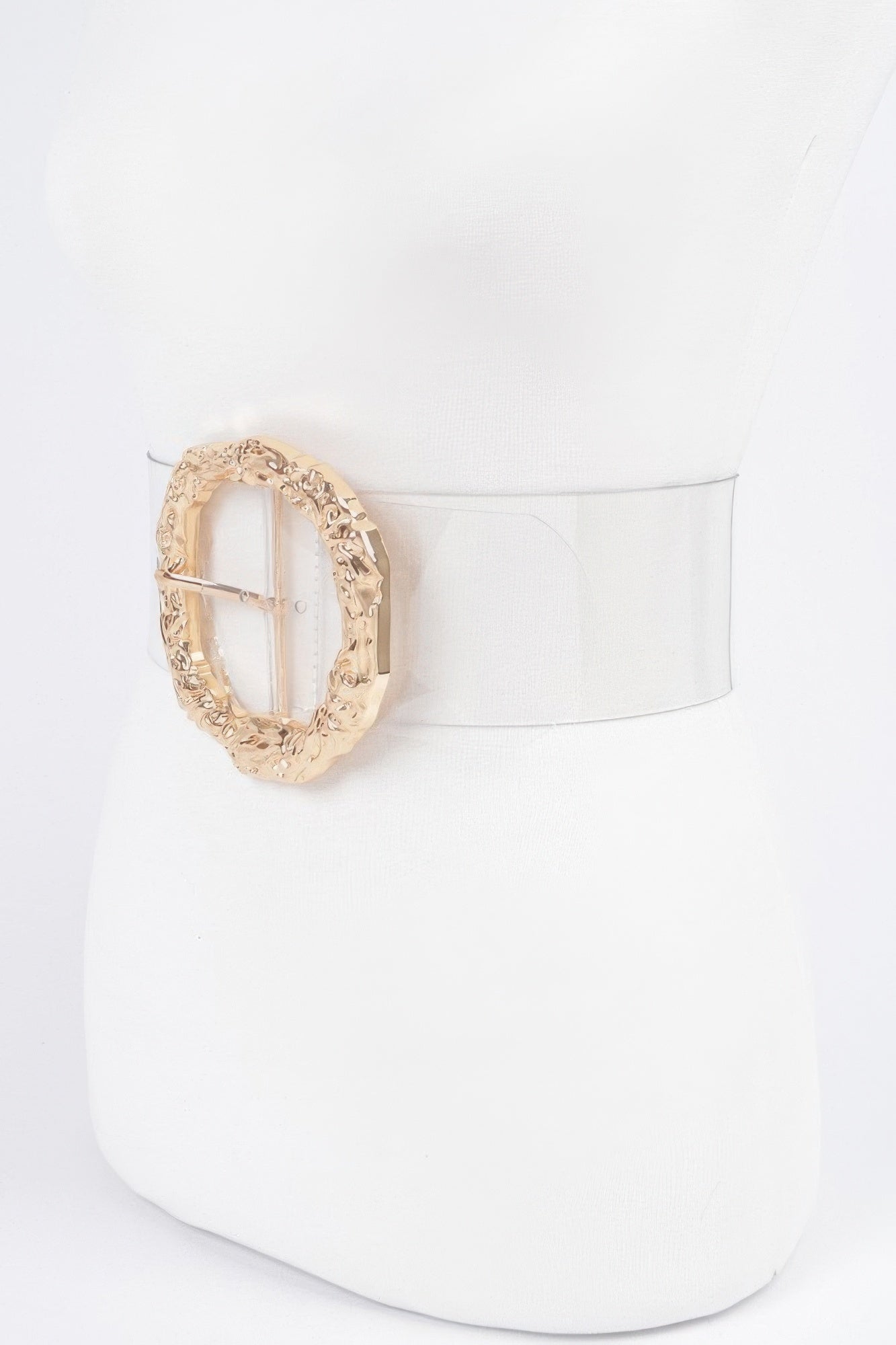 Side view: gold round vintage buckle with textured metal on clear belt strap