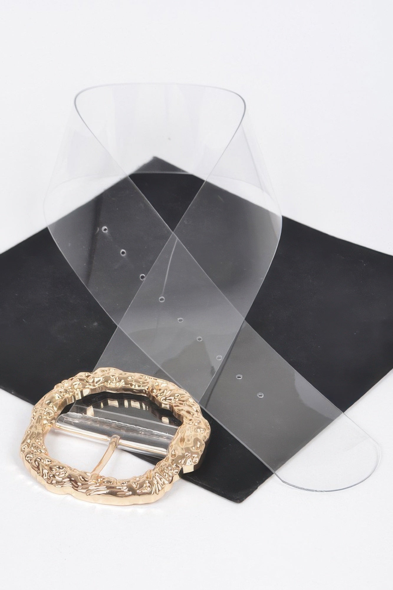 Gold buckle detail: large round ornate vintage metal buckle on clear belt strap