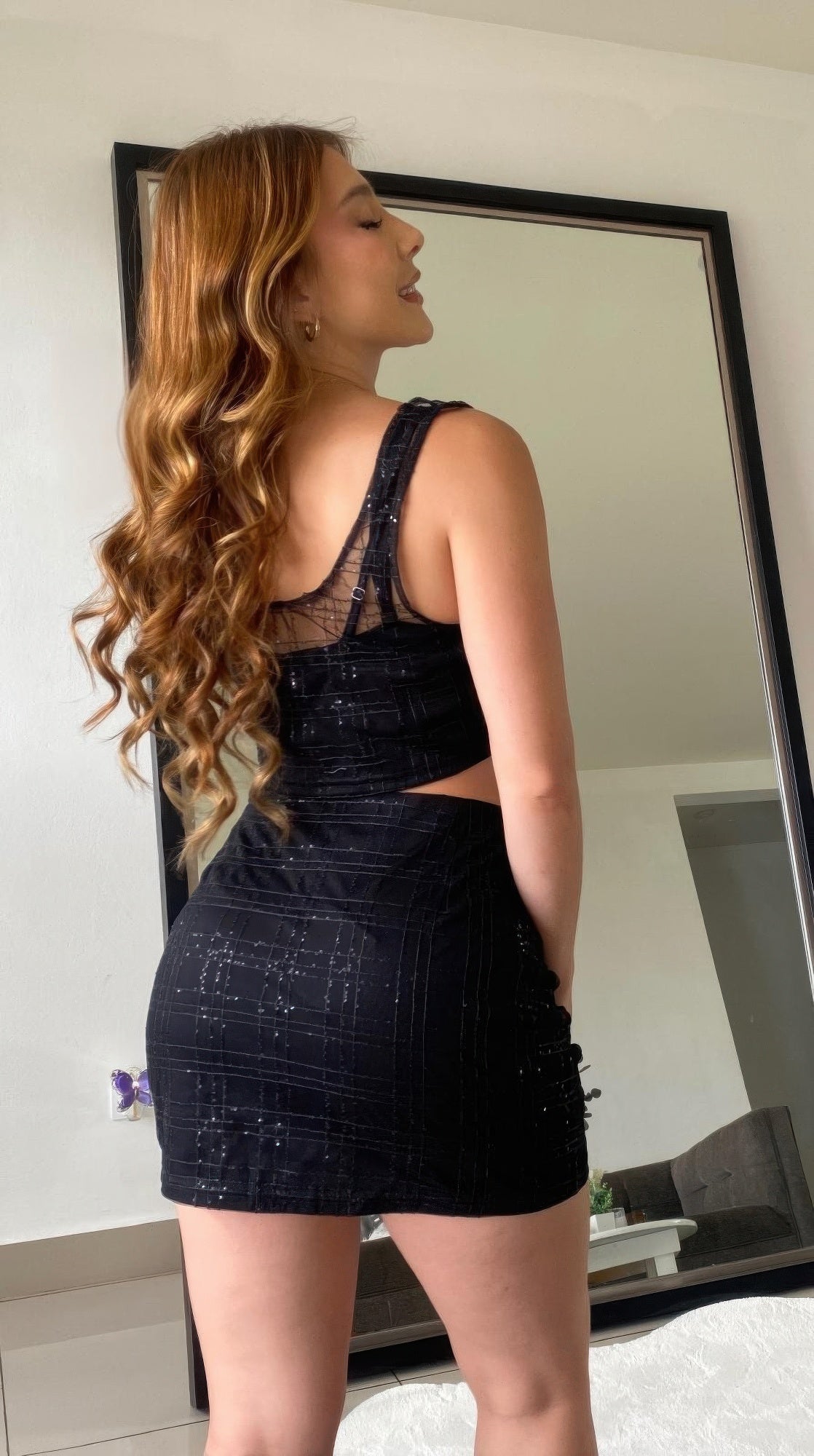 Black sequin crop top and mini skirt set, side profile