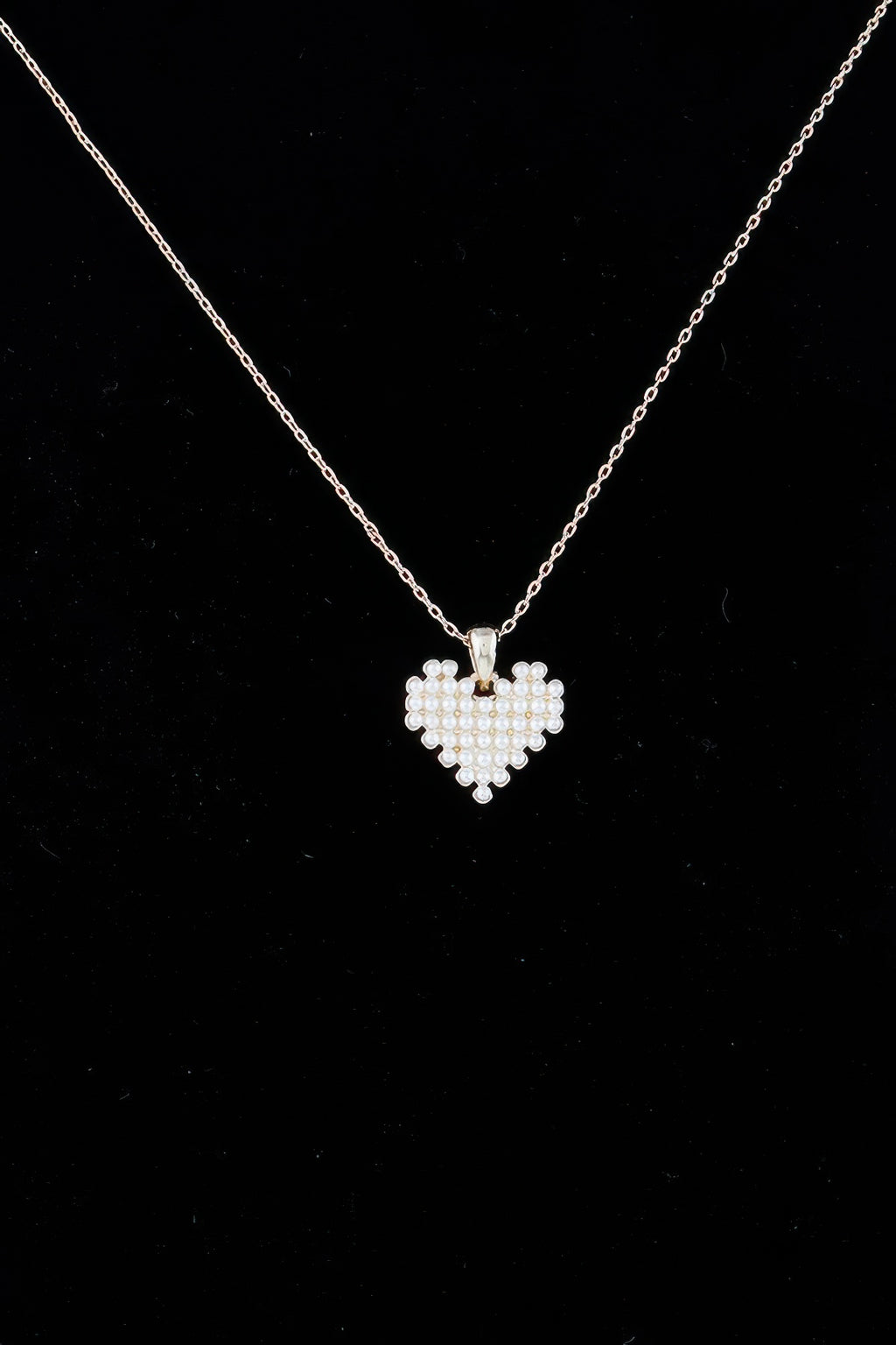 Heart-shaped pearl pendant on gold-tone chain with visible clasp top
