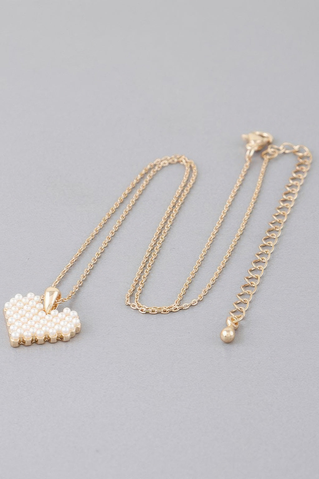 Gold-tone chain necklace with pearl block heart pendant and clasp