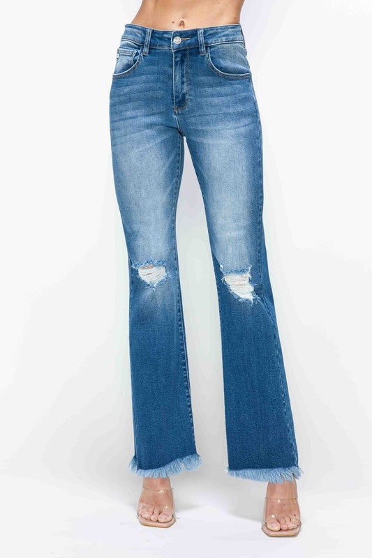 Medium blue high-rise bootcut jeans with raw frayed hem and ripped knees