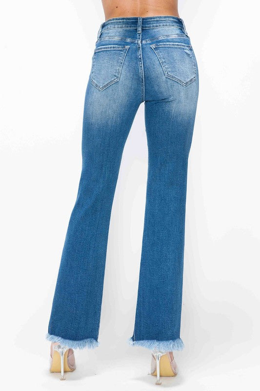 Medium blue bootcut jeans, high rise; raw frayed cuffs and back seams