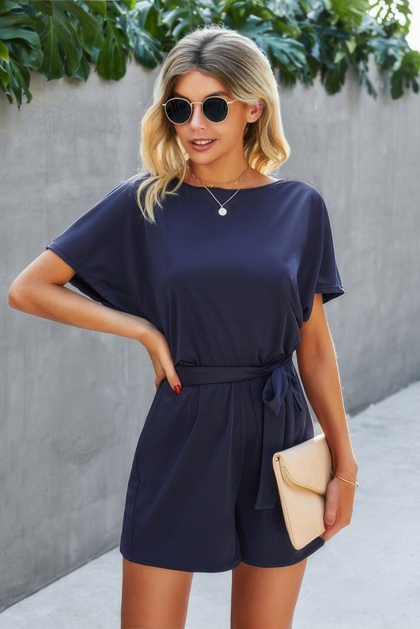 Navy short-sleeve romper with boat neckline and waist tie, loose shorts