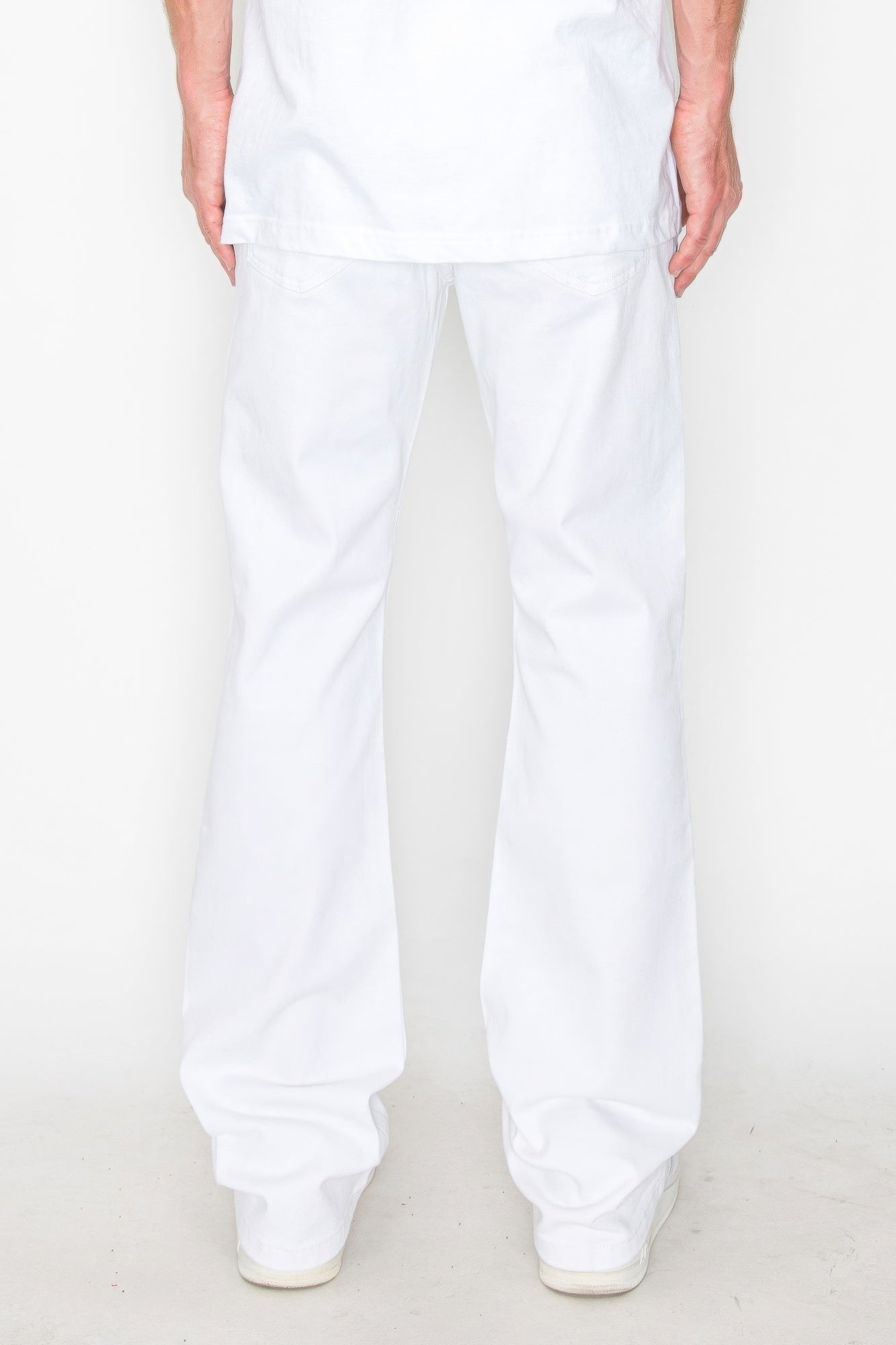 White bootcut jeans with subtle repaired rips at the knees, relaxed fit
