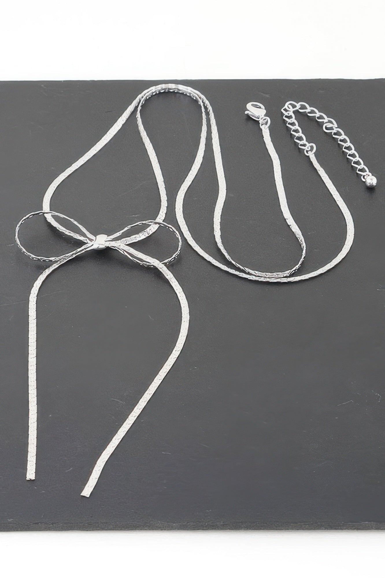Bow necklace bow pendant with long chain tassels, silver-tone close-up
