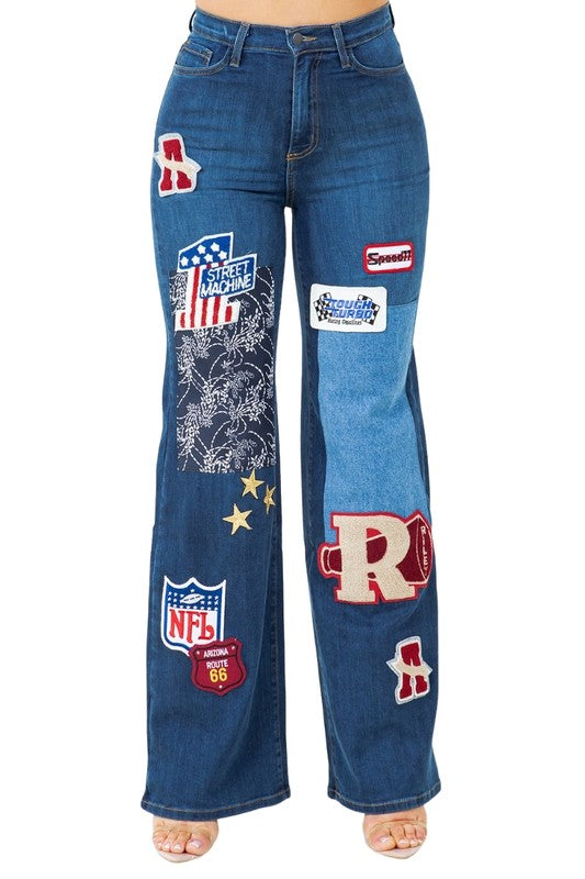 Dark wash wide-leg jeans with large front leg patch designs and belt loops