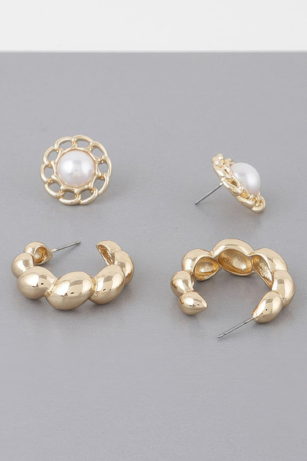Gold chunky hoop earrings with white pearl detailing and hinged post backs