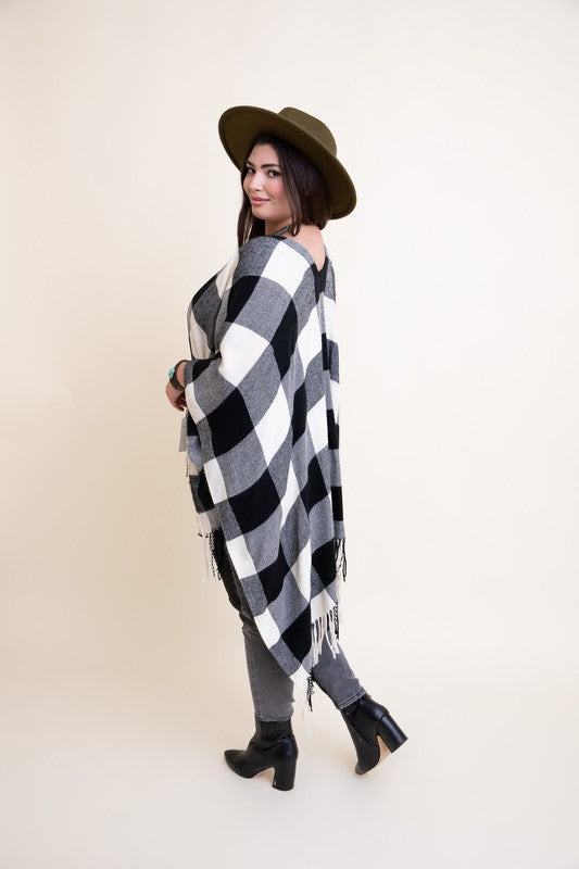 Black-and-white plaid tassel poncho, side view with fringe on hem