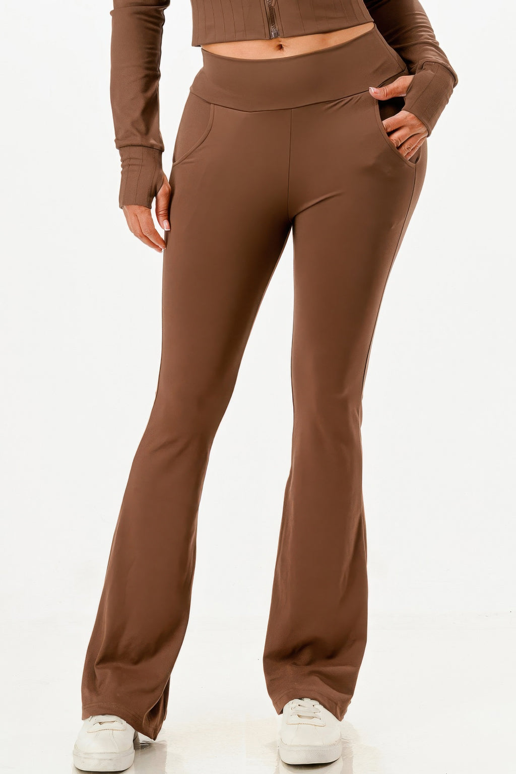Close-up of brown high-rise flare pants with side pockets and straight leg opening