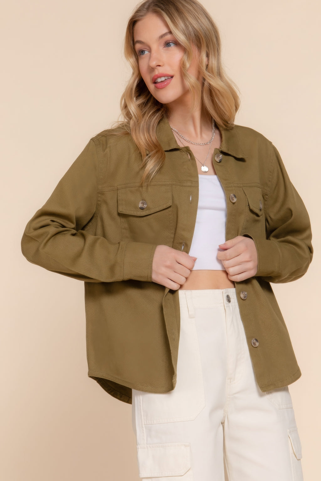 Olive denim shacket close-up: button front, chest flap pockets, and long sleeves