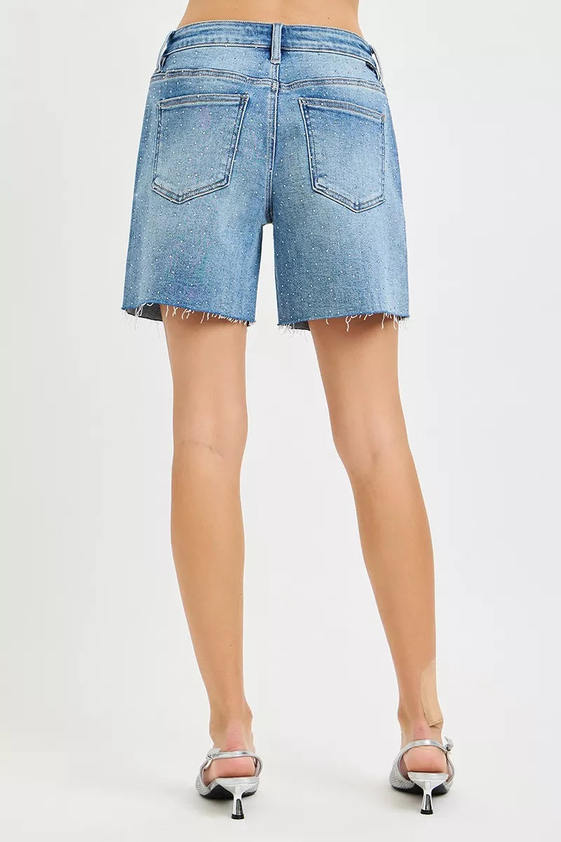 Medium blue denim shorts, back view with all-over rhinestones, frayed mid-length hem