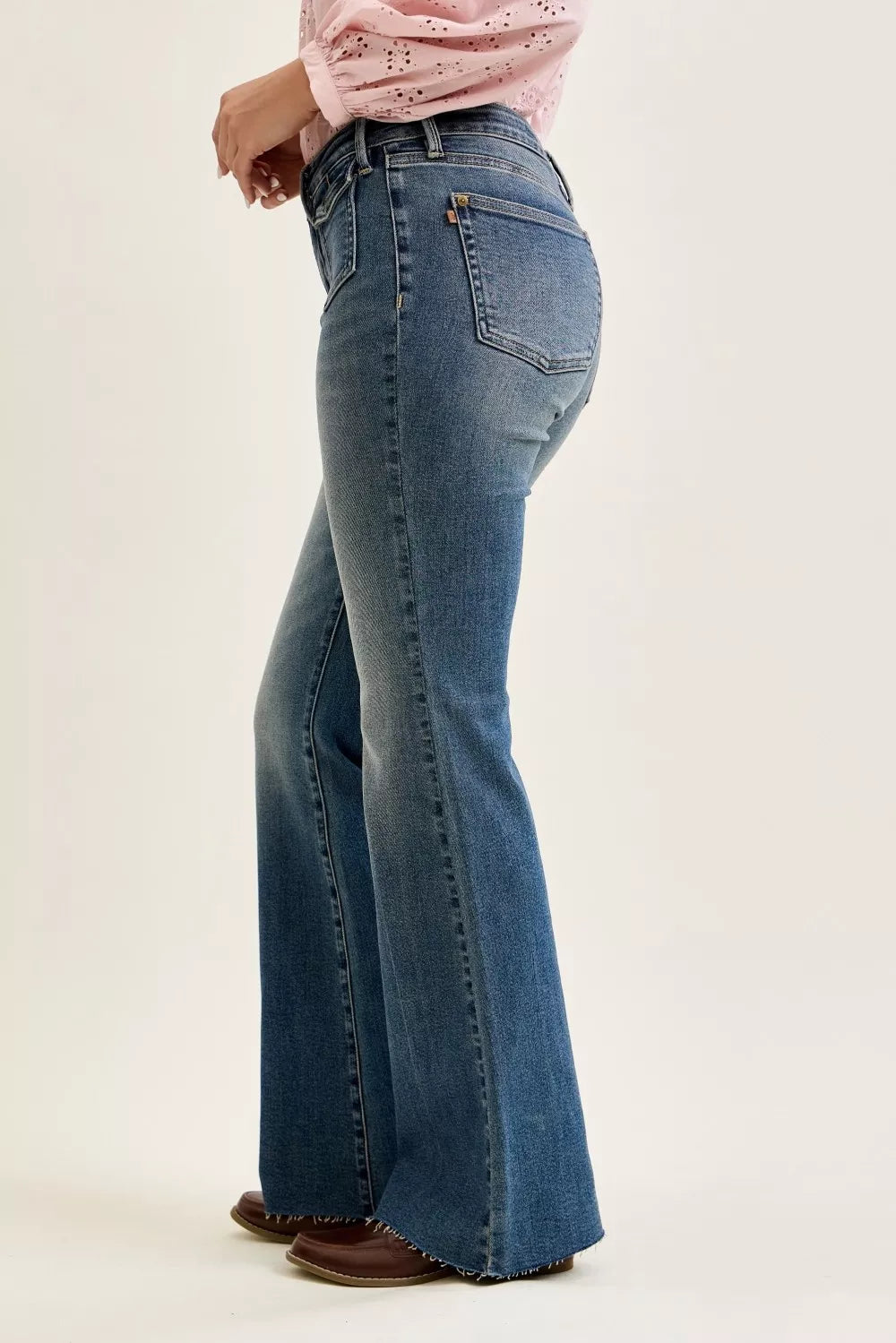 Mid-rise flare jeans in dark wash denim with back yoke seam and rear pockets