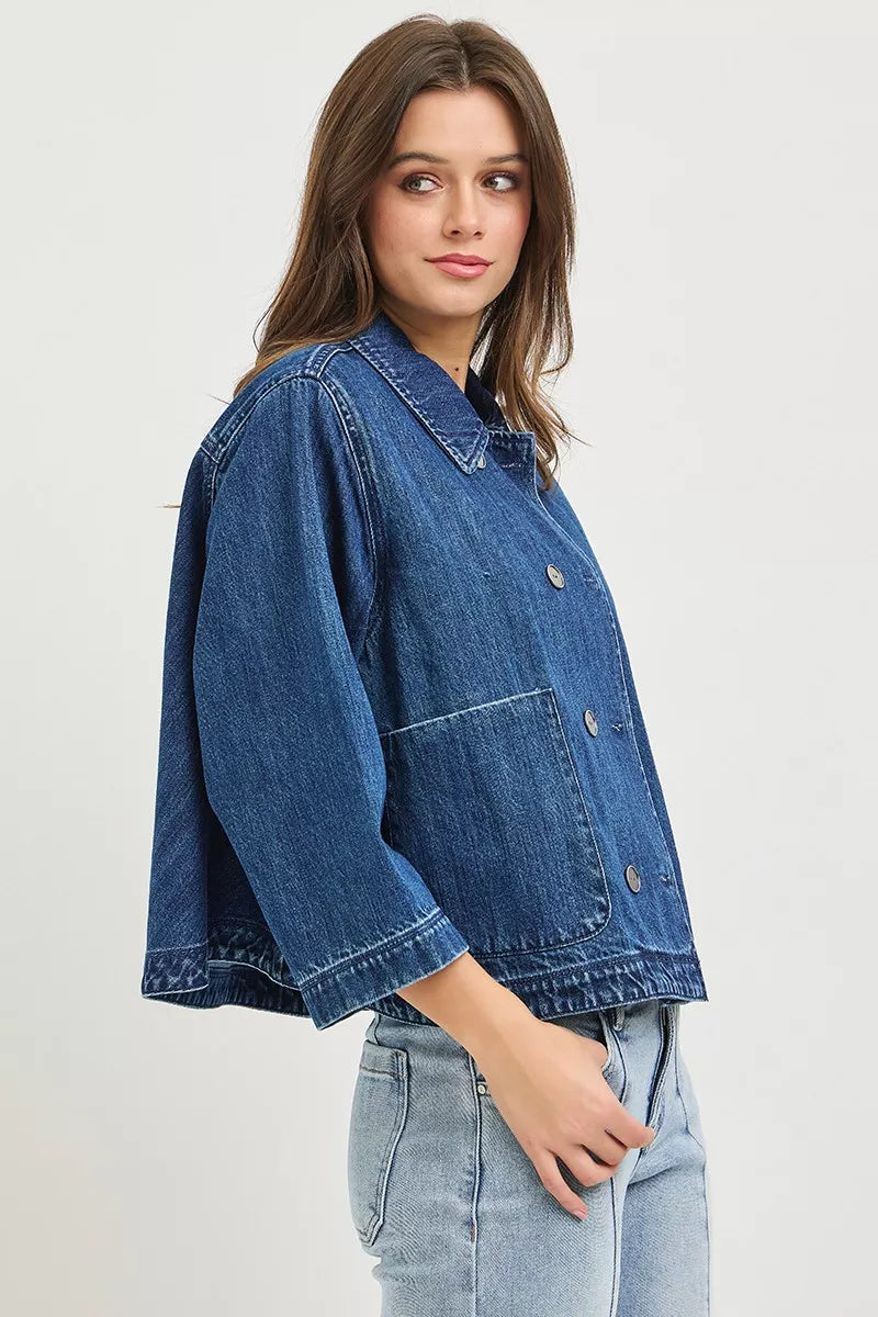 Dark blue denim cropped jacket with wide sleeves, buttoned front and chest flap pockets
