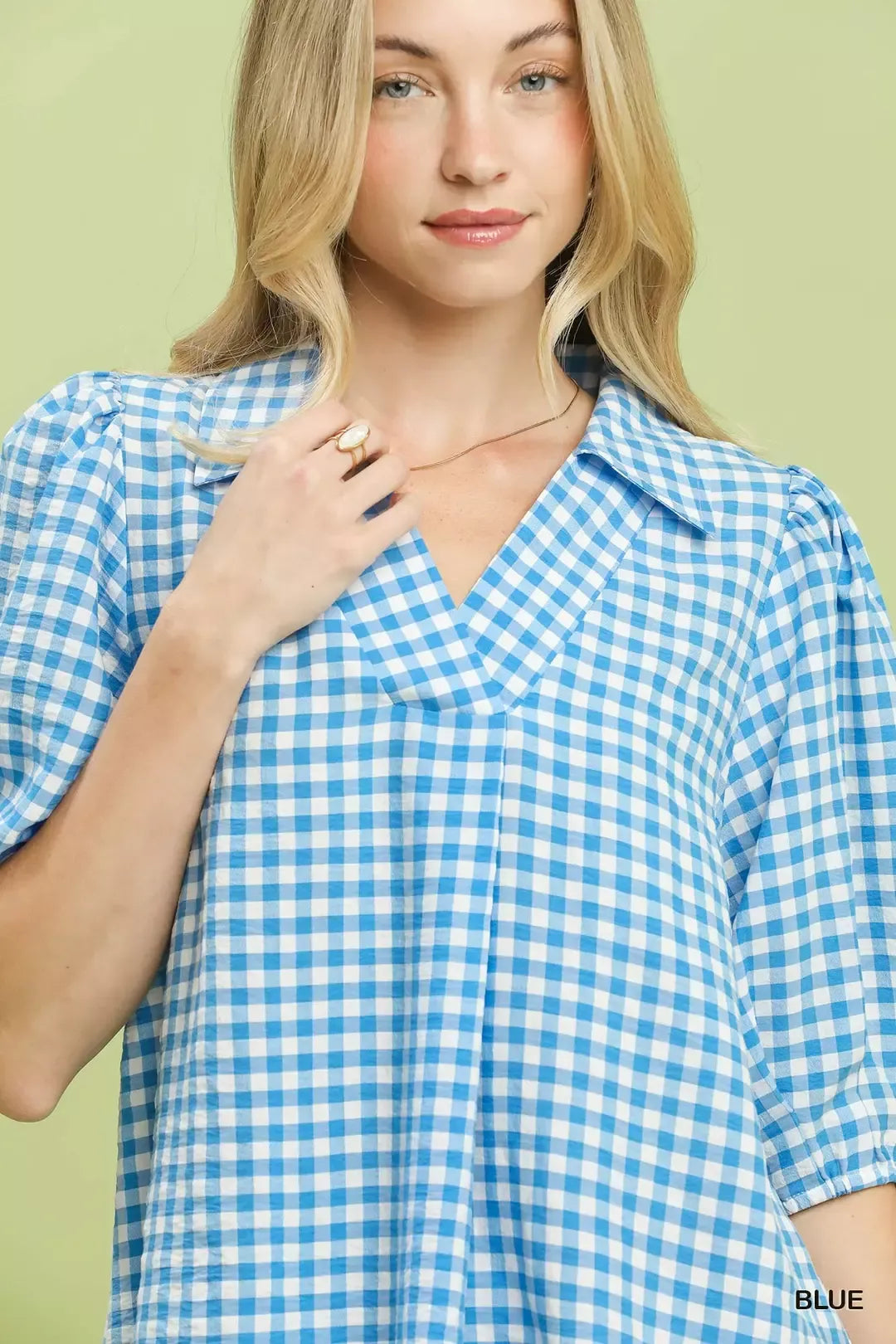 Blue gingham collared blouse with puff sleeves and buttoned V-neck close-up