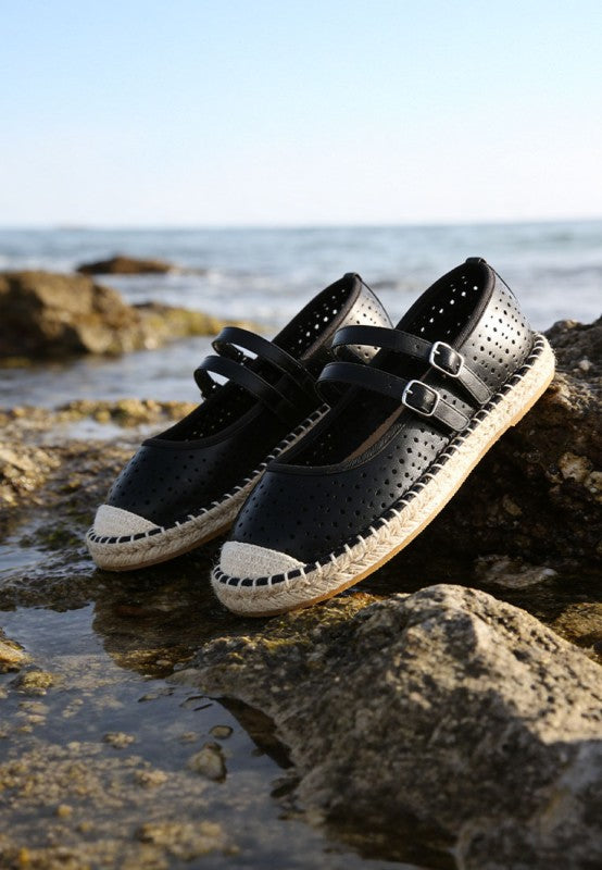 Black woven dual buckle flats with perforated upper, adjustable straps, textured espadrille sole