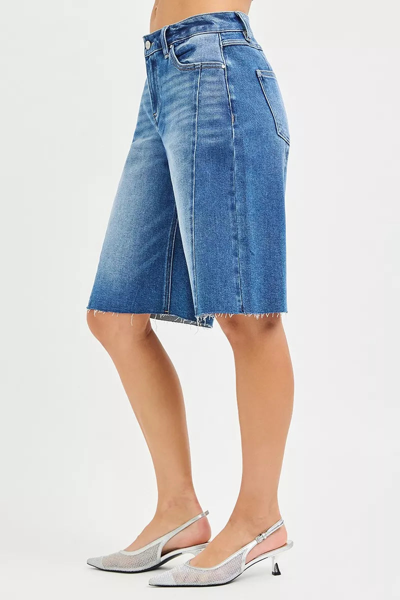 Slouchy seamed jorts side view, medium wash denim with raw hem and seam details