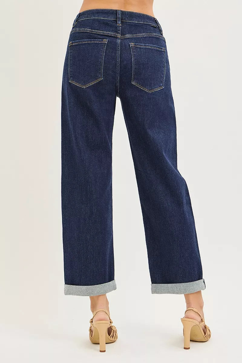 Dark blue boyfriend jeans back view with two patch pockets and cuffed hem.