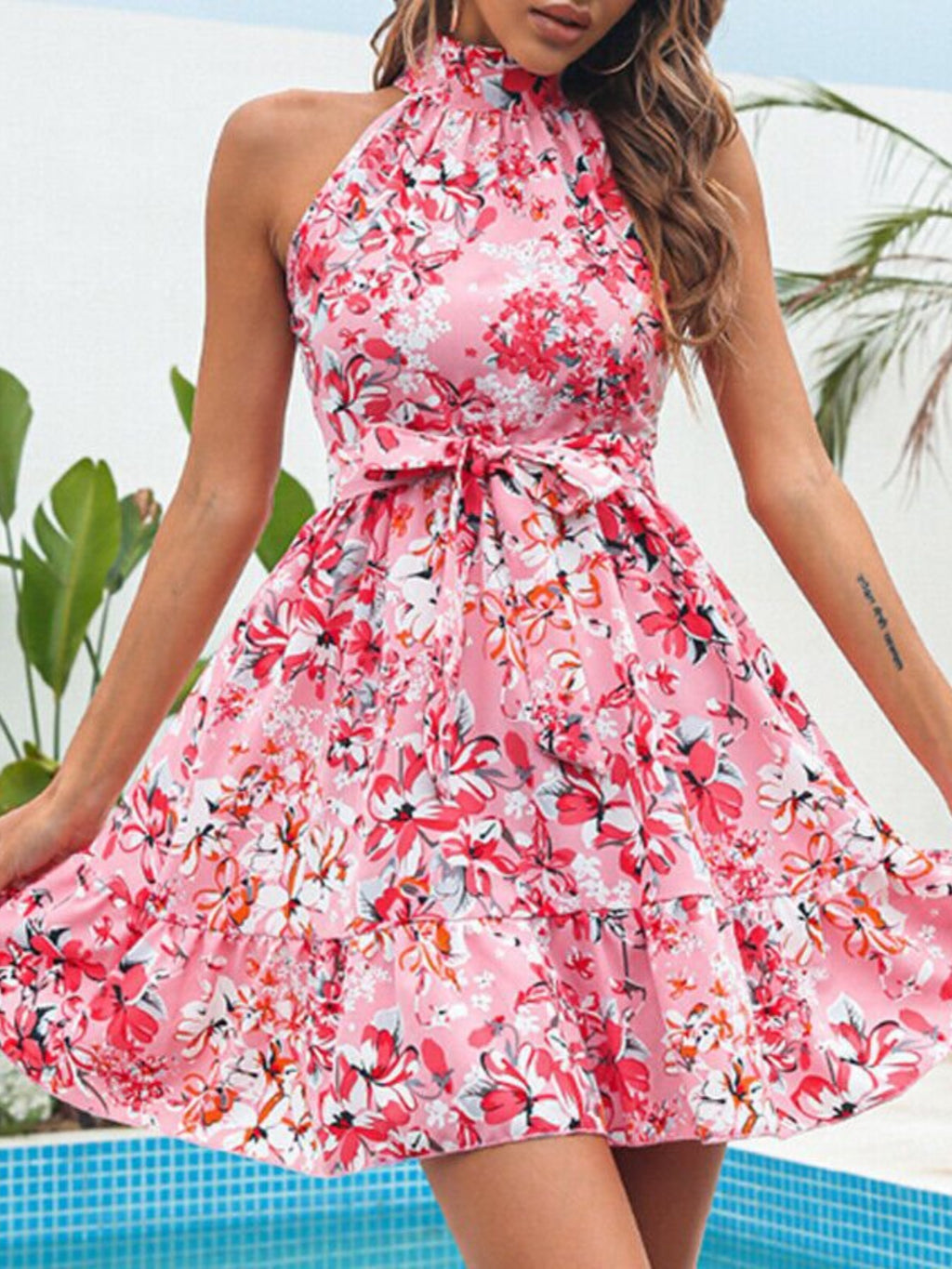 Pink floral halter neck mini dress with gathered waist and ruffle hem