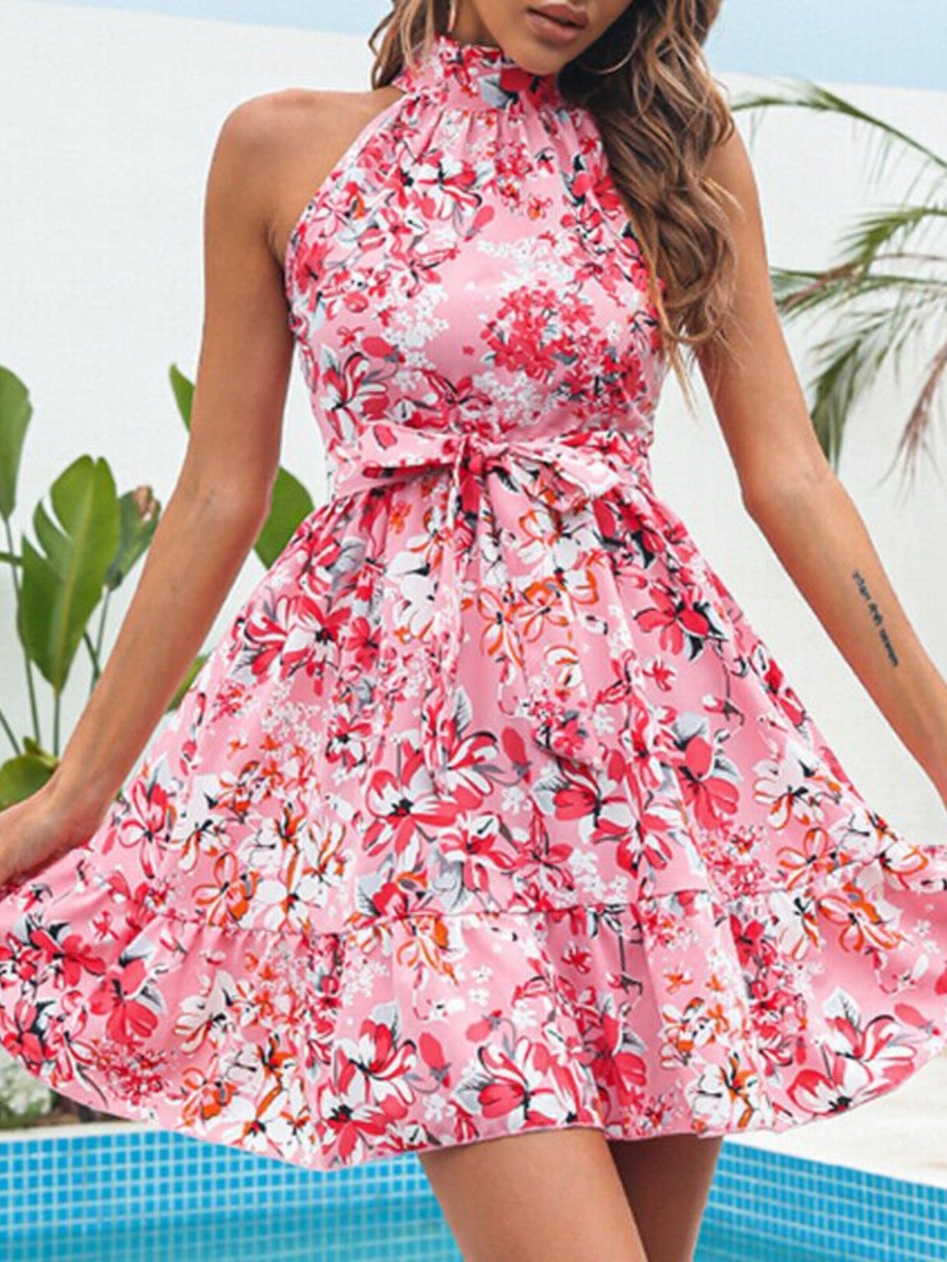Pink floral halter neck mini dress with gathered waist and ruffle hem