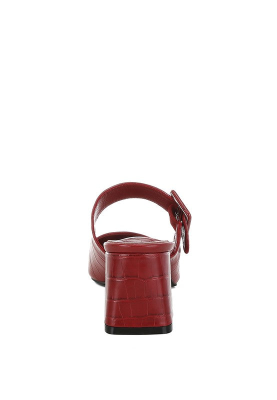 Dk Red mule heel with adjustable buckle strap and croc-textured finish, rear view