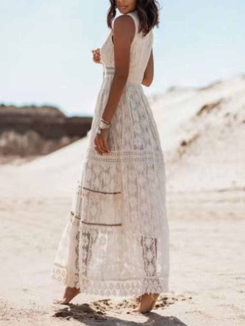 White lace sleeveless maxi dress, side view with tiered hem and patterned panels