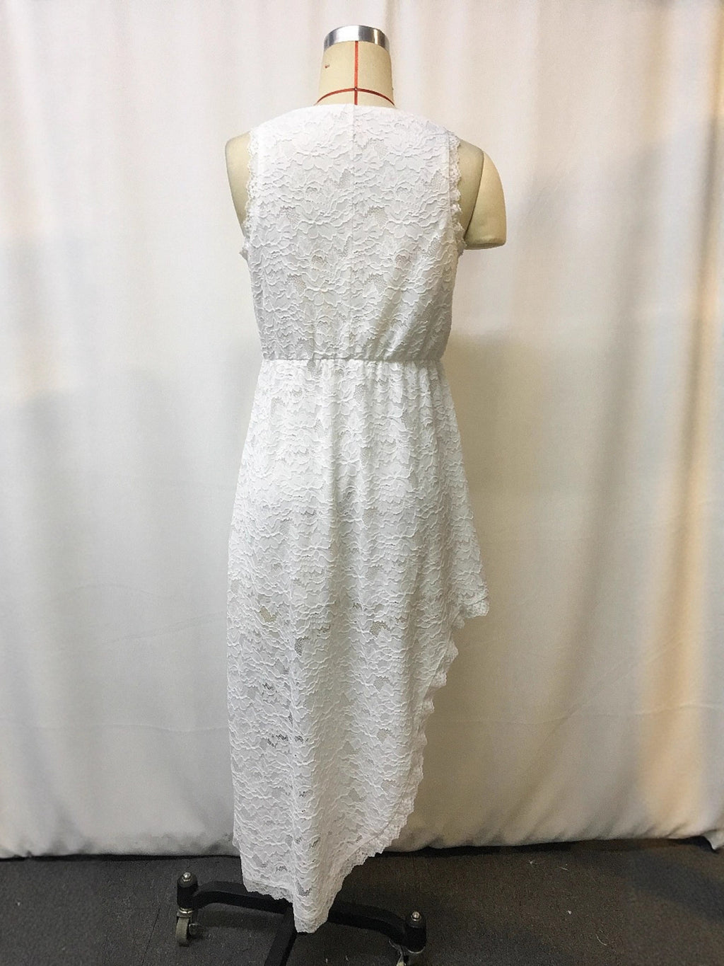 White lace sleeveless dress, back view with V-back and asymmetric skirt hem