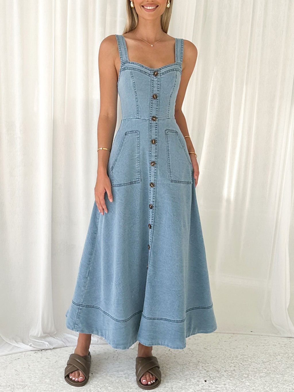 Light blue denim A-line dress with button front and patch pockets; sleeveless square neck