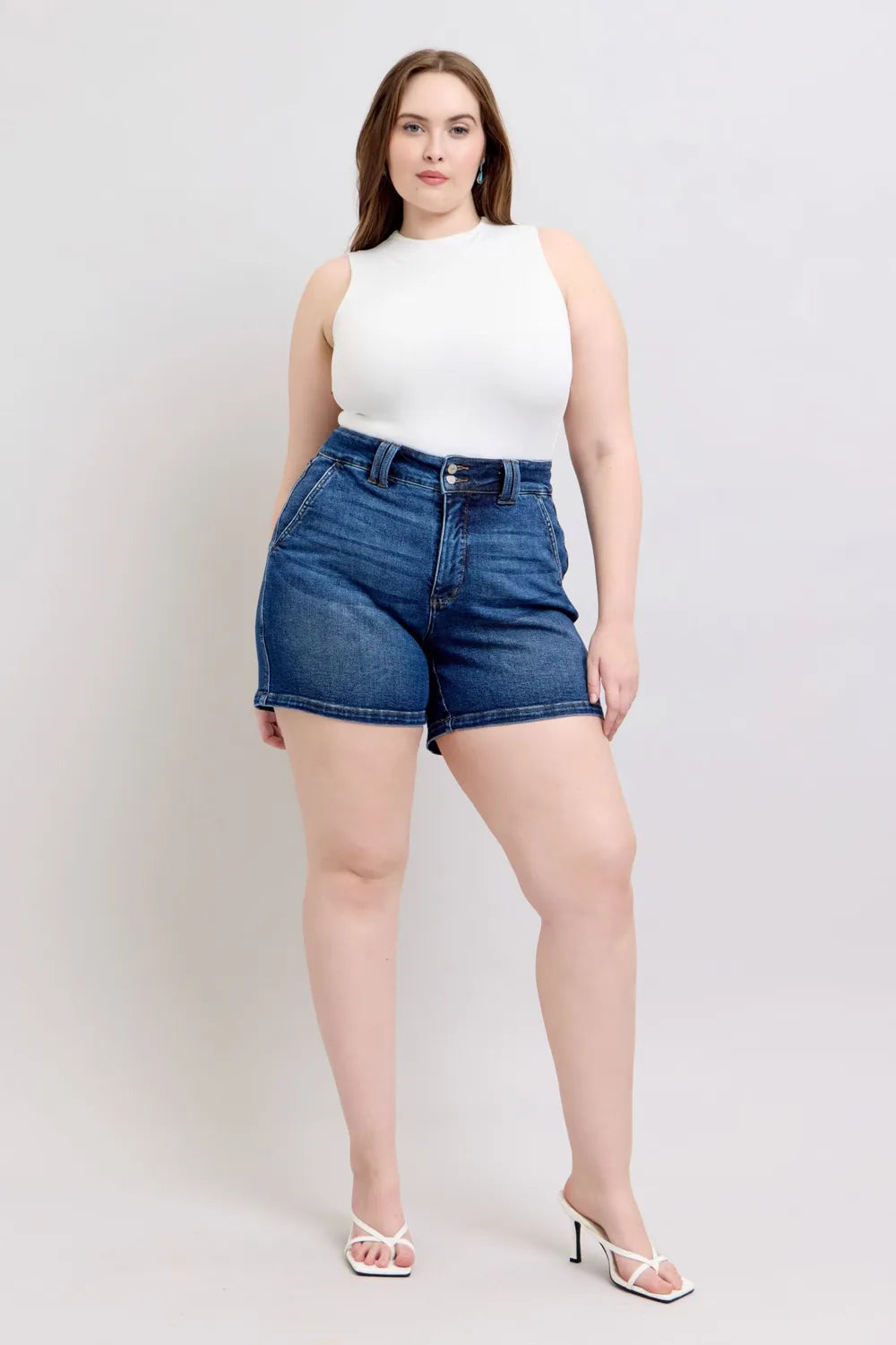 Dark denim shorts with front button fly and double-button waistband, straight hem