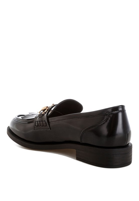 Black loafers from the side with gold horsebit accent and fringe trim, low block heel