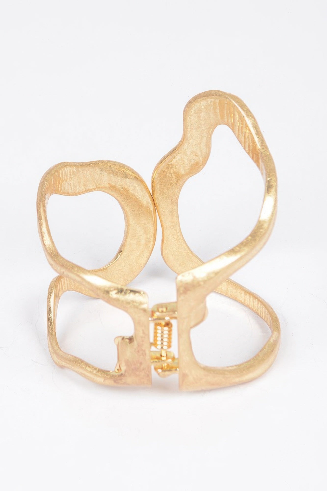 Gold spring hinge cuff bracelet with textured oval and wide linked design
