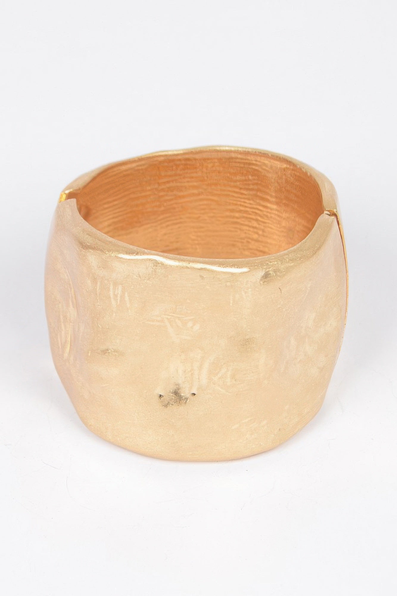 Gold cast metal spring hinge cuff bracelet with hammered texture