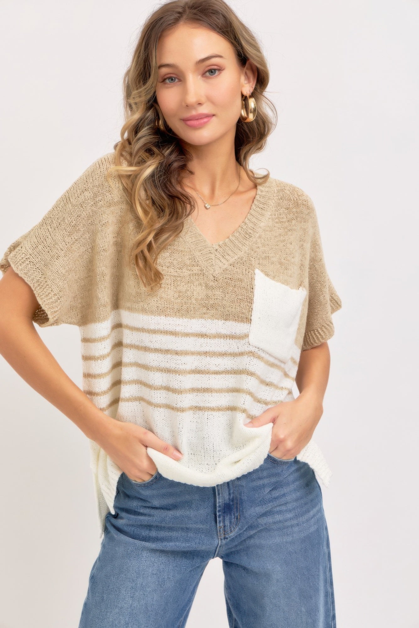Taupe oversized knit top with V-neck, short sleeves, striped hem and white chest pocket