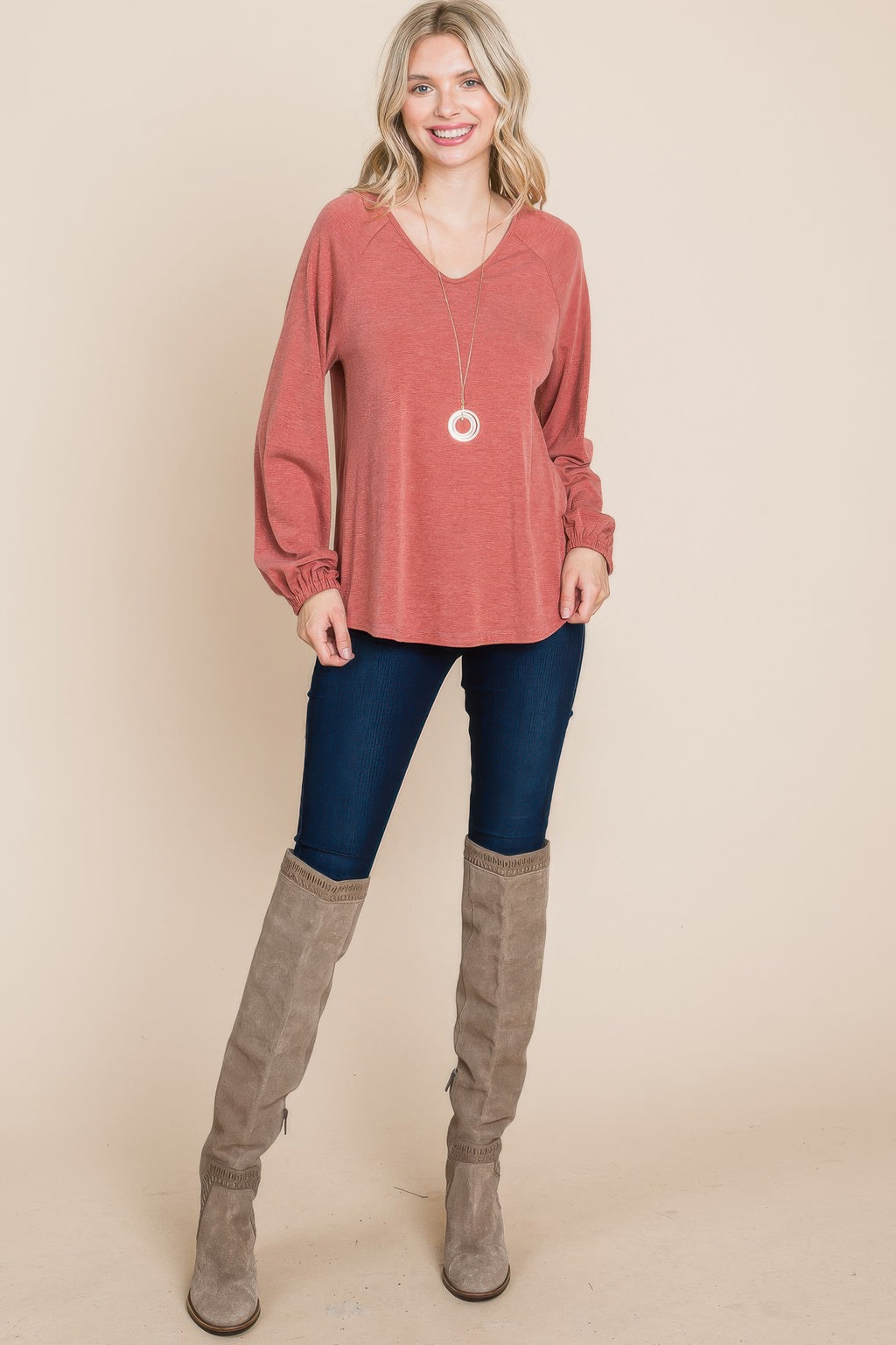 Rust V-neck long-sleeve top with gathered cuffs and flowy hem