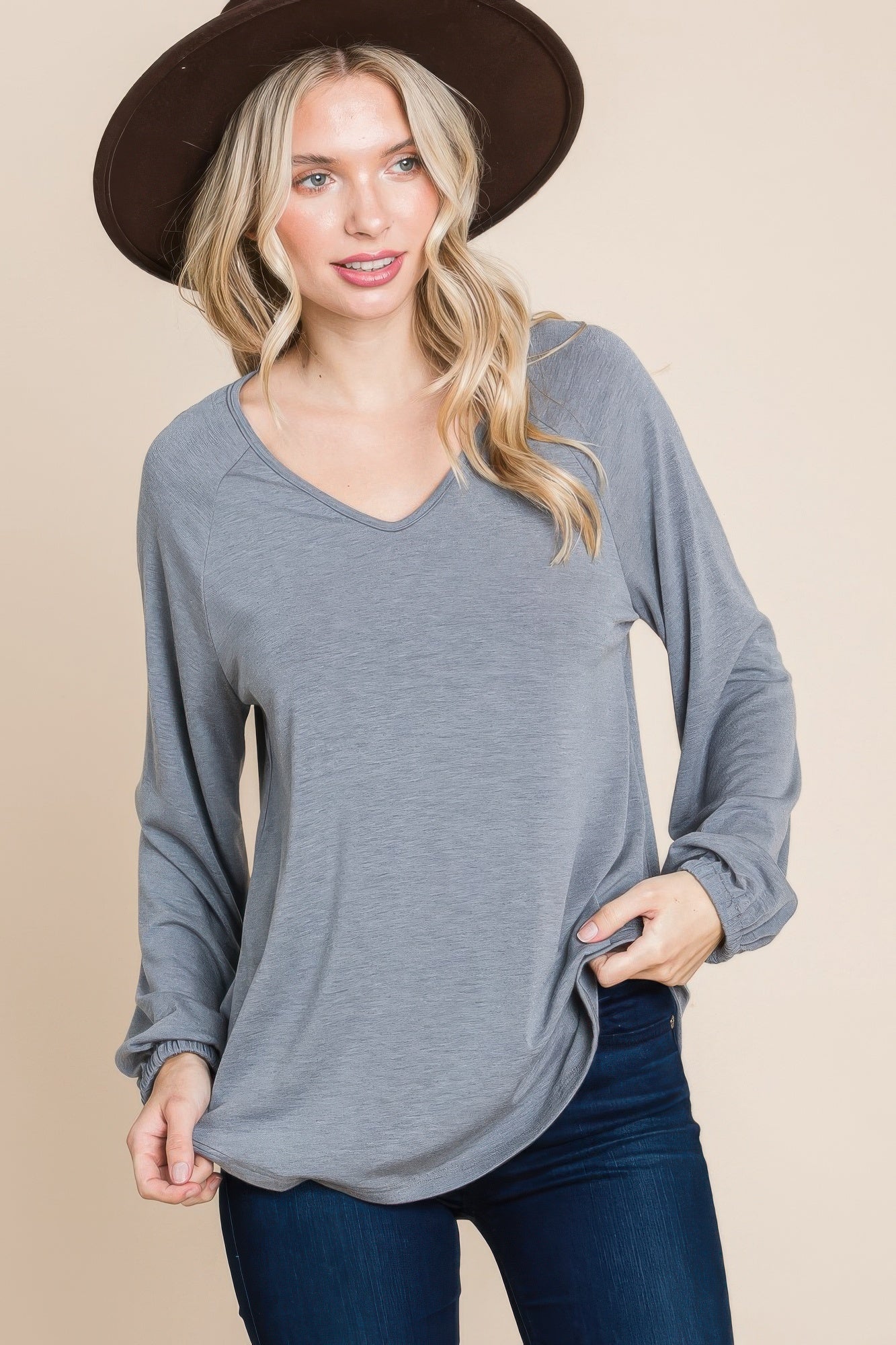Grey V-neck long-sleeve top with cuffed sleeves and relaxed fit
