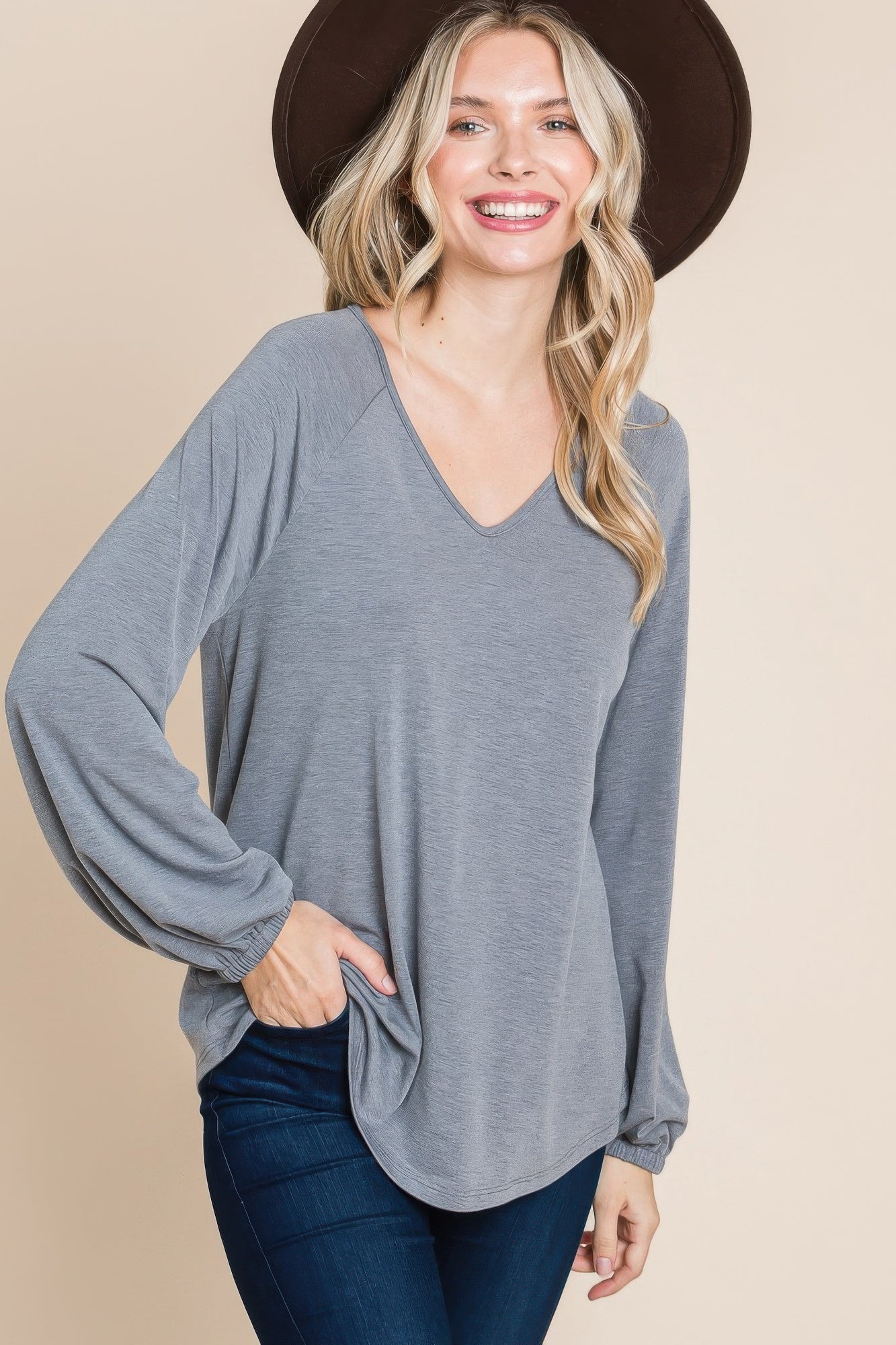 Grey V-neck long-sleeve top with cuffed wrists and slightly curved hem