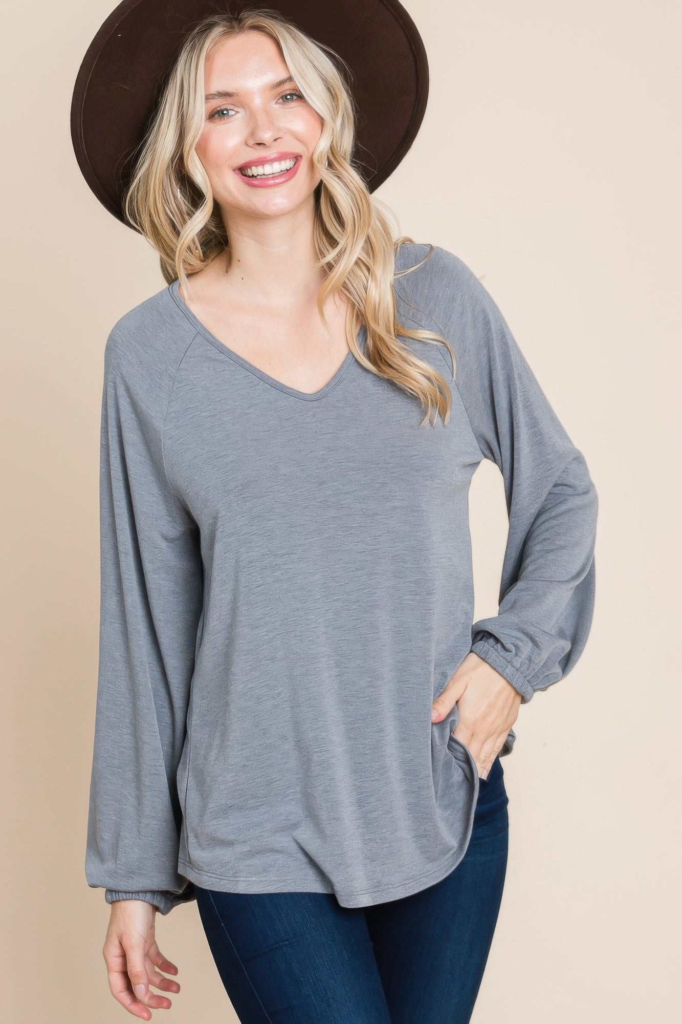 Grey V-neck long-sleeve top with cuffed sleeves and loose fit through torso