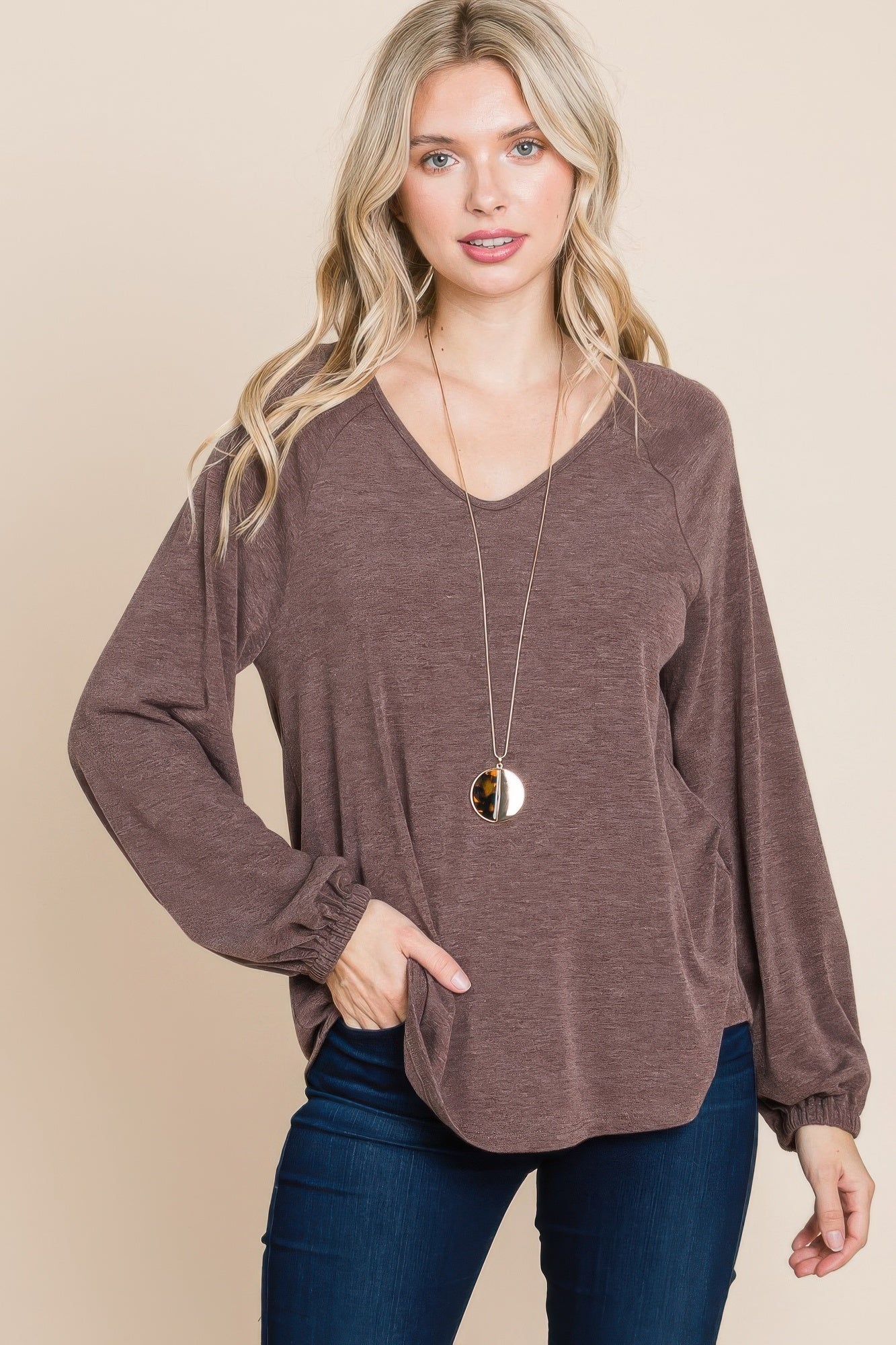 Dark brown V-neck long sleeve top with relaxed fit and gathered cuffs