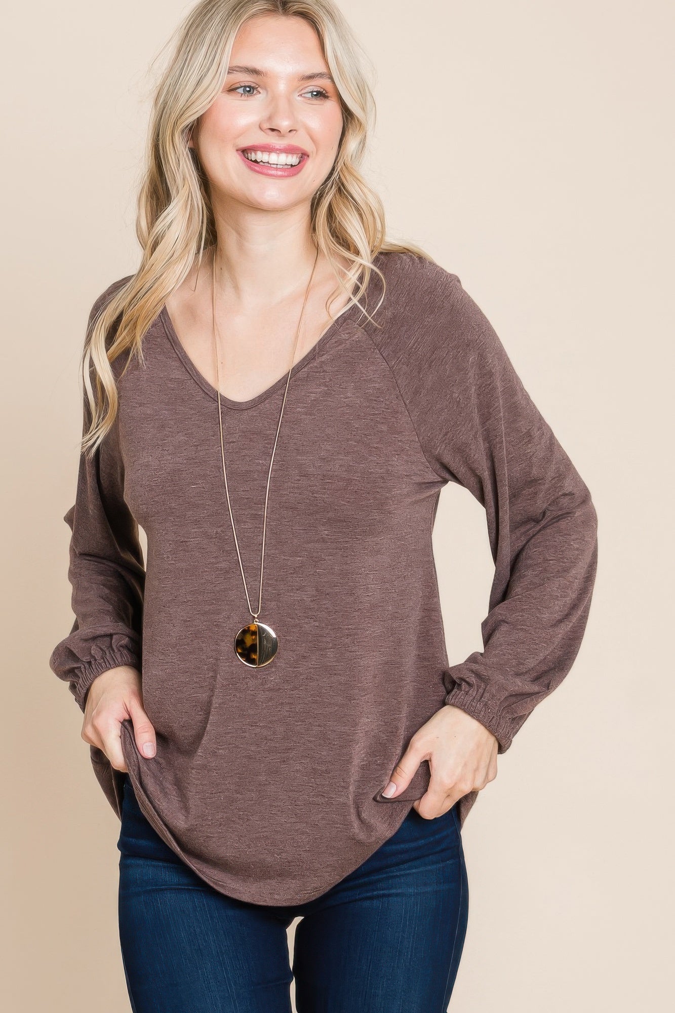 Dark brown V-neck long sleeve top, slightly curved hem and gathered wrists