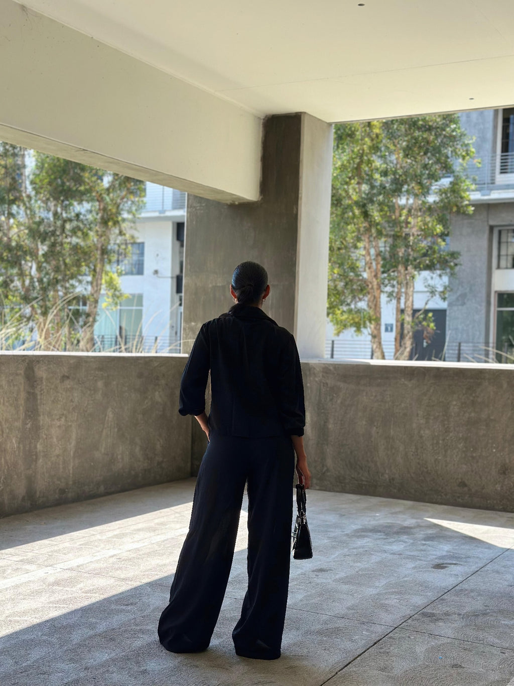 Back view of tied-front long-sleeve top with wide-leg pants set