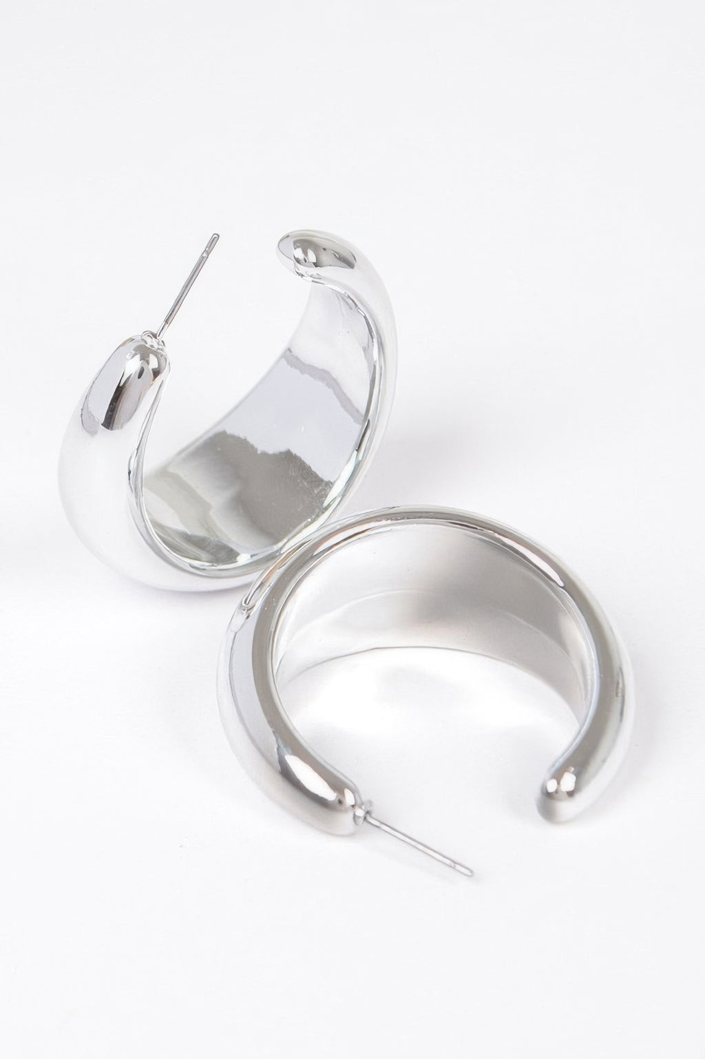 Silver crescent hoop earrings with glossy finish and straight pin posts