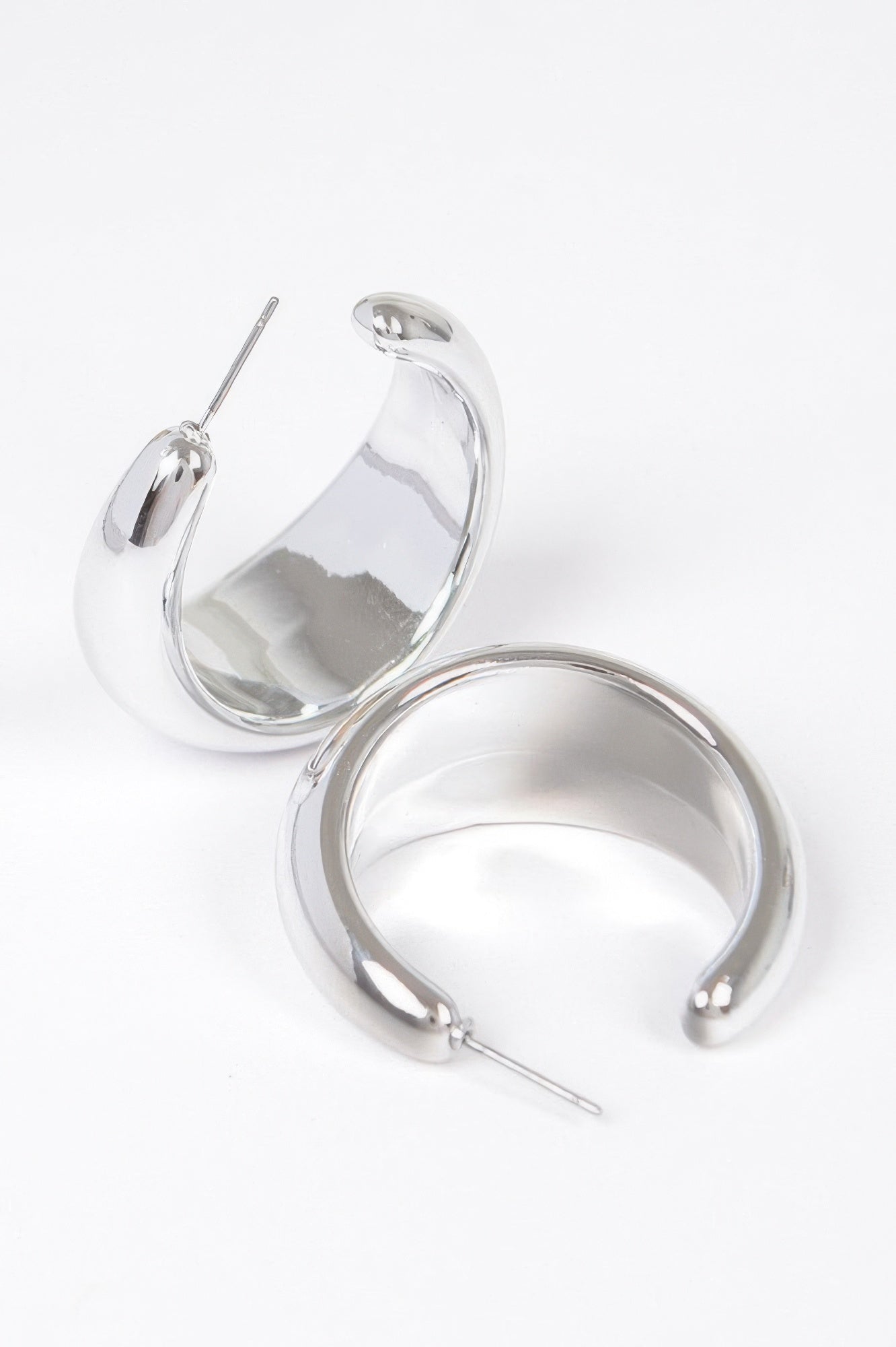 Silver crescent hoop earrings with glossy finish and straight pin posts