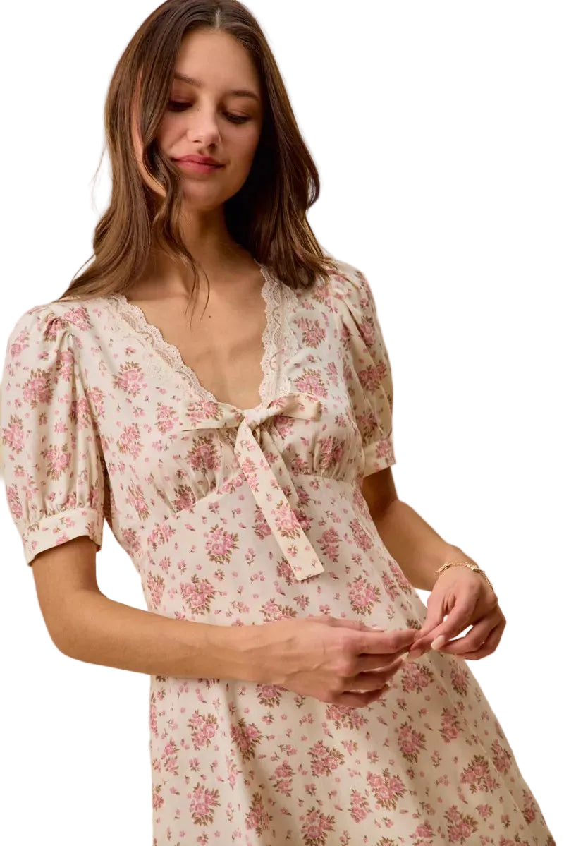 Cream floral mini dress detail: lace V-neck trim and bow-tied front