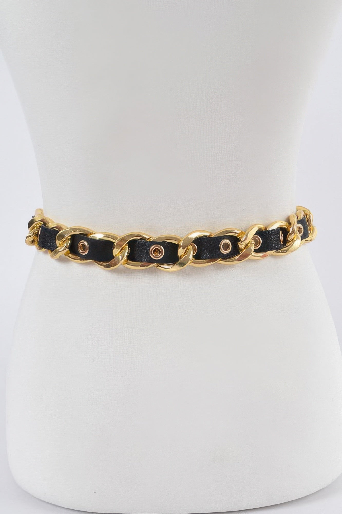 Chain fashion belt with black strap and gold-tone oval links, no dangling hardware visible