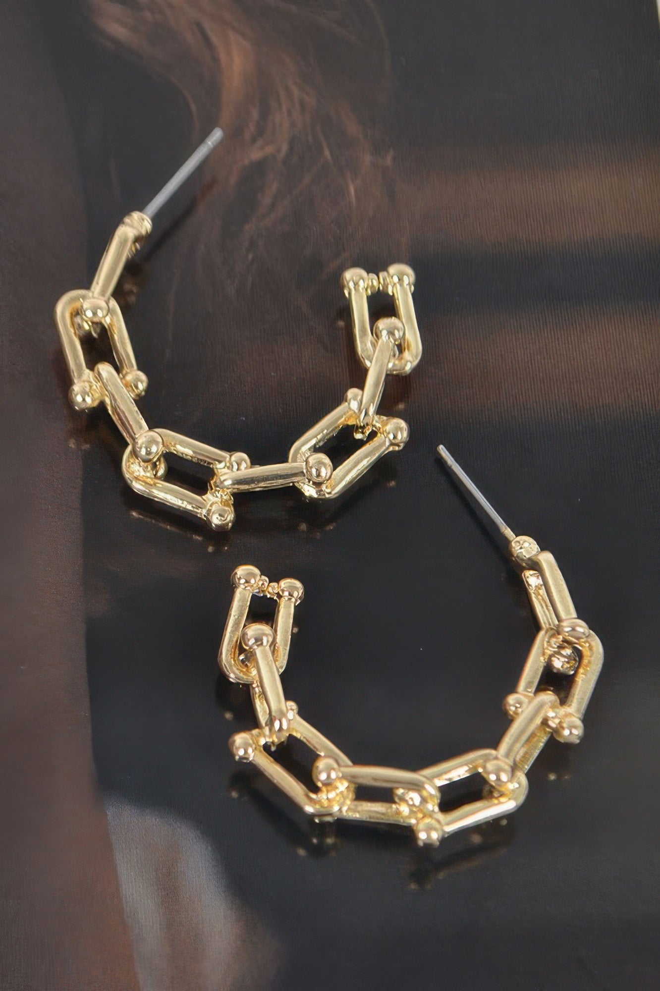 Gold-tone chain hoop earrings with rectangular links and small stud posts