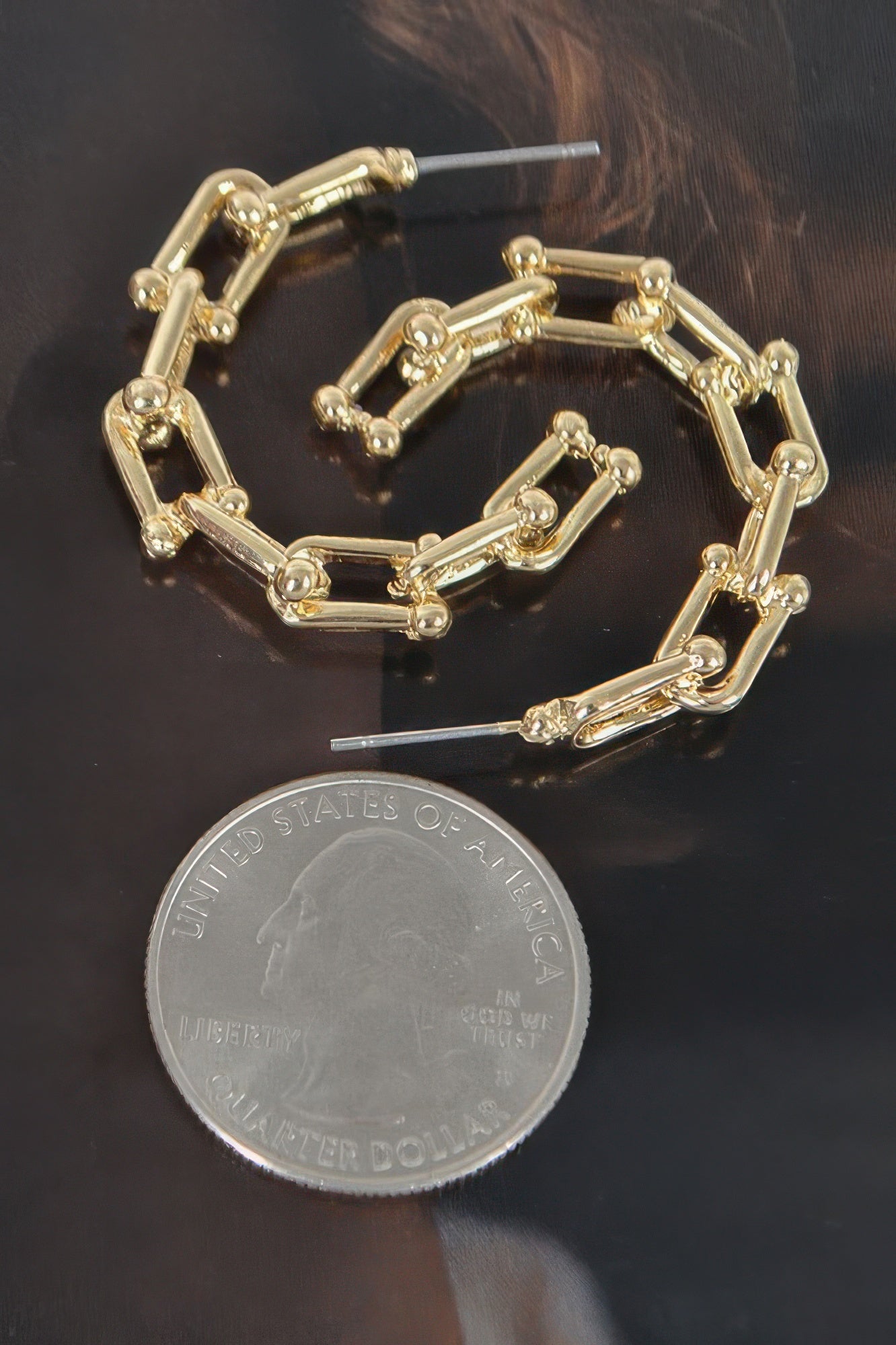 Gold-tone chain hoop earrings with chunky rectangular links and stud closure
