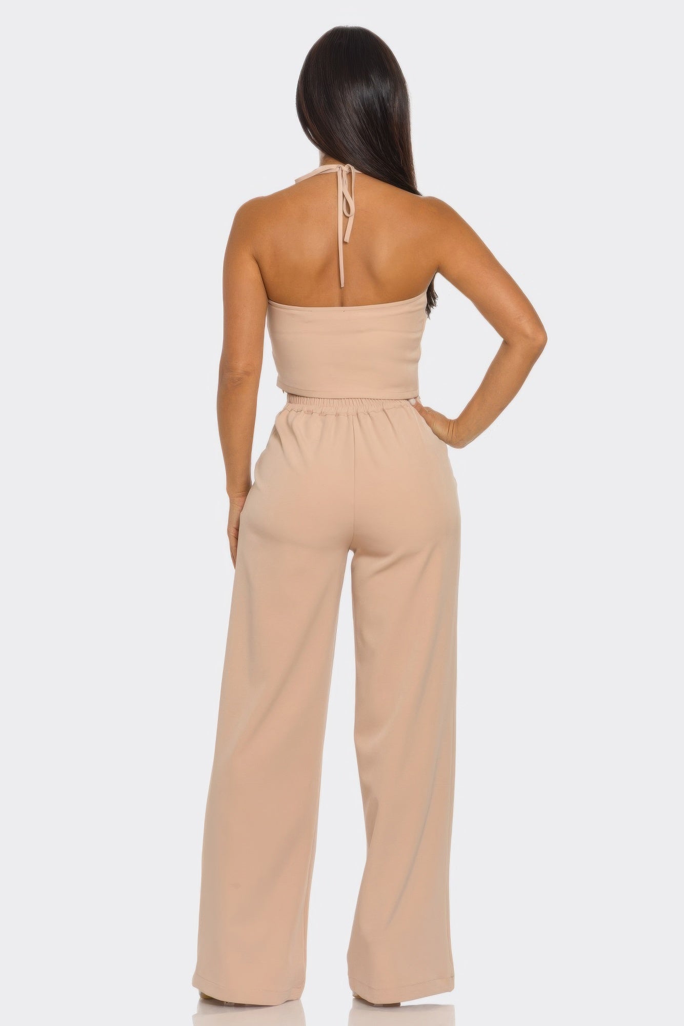 Back view: blush halter crop top with tie-back and matching wide-leg pants
